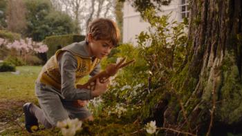 Velveteen Rabbit TV: William, a young white boy, plays with his stuffed animal rabbit outside
