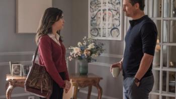 The Watchful Eye TV show screenshot: A woman stands in a living room talking to a man with his hands in his pockets.