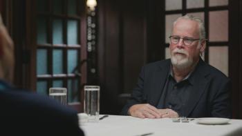 The Wonderland Massacre TV show screenshot 1: Michael Connelly sits at a dinner table during an interview.