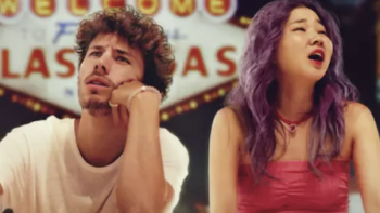 The Worst Trip Around the World TV show screenshot 2: Juanpa Zurita sits with Chingu Amiga in front of iconic Las Vegas casino sign. 