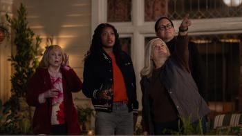 The 'Burbs TV show screenshot: Neighbors stand on a porch, with shocked looks. 