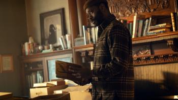 The Changeling TV show screenshot 1: Apollo examines books at an estate sale.