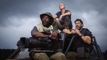 The Wild Ones TV show screenshot: Three men in adventurer clothing pose on an off-roading vehicle looking in different directions