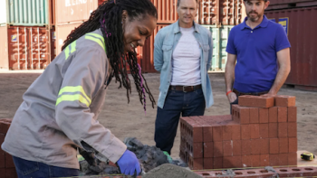 Tough as Nails TV Show: A contestant quickly lays brick and mortar
