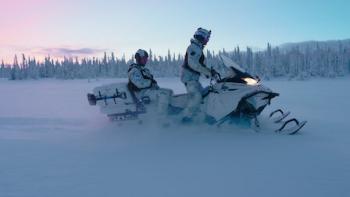 Toughest Forces on Earth TV show screenshot: Two men in snow camouflage ride snow mobiles. 