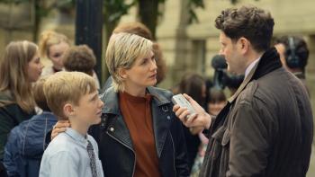 Toxic Town TV show screenshot 3: Susan and her son speak to a reporter