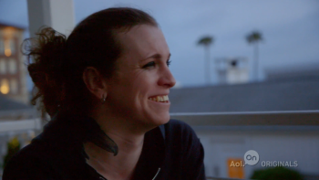 True Trans with Laura Jane Grace TV show: Grace smiles, backlit against darkening sky