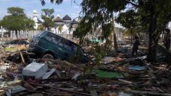Tsunami Race Against Time TV show screenshot: picture of a large amount of post-tsunami debris with a car floating on top.