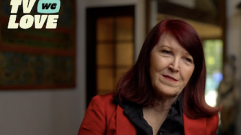 TV We Love TV show screenshot 3: Actress Kate Flannery in red jacket talks to camera.