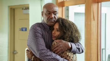 UnPrisoned TV show screenshot: A black man and a black woman are hugging.