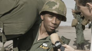 Vietnam: The War that Changed America TV show screenshot 1: Black soldier in uniform speaks into ABC reporter microphone.