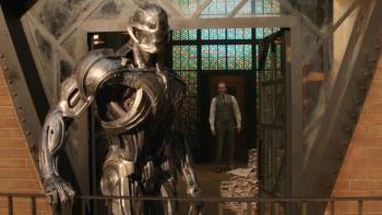 VisionQuest: Ultron, in his robotic form, looks off the balcony of his prison in Vision's mindspace as Vision, in his human avatar, stands at the door