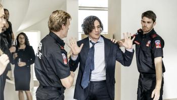 Watching You TV show screenshot 3: Chai Hansen holds his hands in surrender as firefighters grab him. 