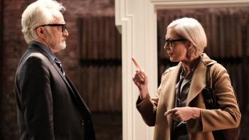 A West Wing Special TV Show: Deputy Chief of Staff Josh Lyman faces and listens to Press Secretary CJ Cregg, who is shaking her pointer finger at him as though lecturing him