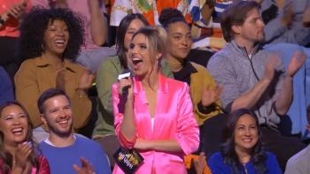 Wish List Games: Host Lele Pons stands in a bright pink suit in the studio audience.
