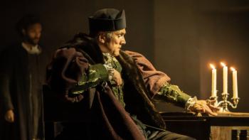 Wolf Hall: The Mirror & the Light TV show screenshot 2: Cardinal Wolsey is seen in a dim room, staring fixedly at a candelabra.