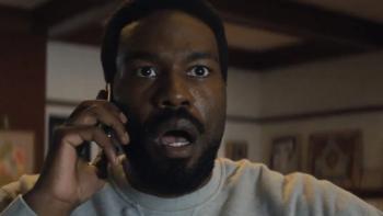 Wonder Man: Simon holds a telephone in a close-up shot; he looks to have received alarming news as his face is shocked 