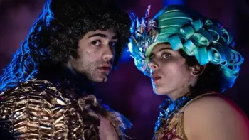 Wonderboys The Secret Treasure of Naples TV: Toni and Anto dressed in vintage clothing and wigs stand face to face looking suspiciously off camera.
