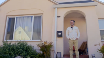 Worst Neighbor Ever screenshot 2: Man standing on porch of a beige house with plants and rocks.