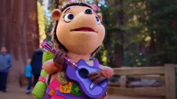 Wowsabout! TV: Roxy looks at something off screen as she arrives at the National Park with her purple guitar in hand.