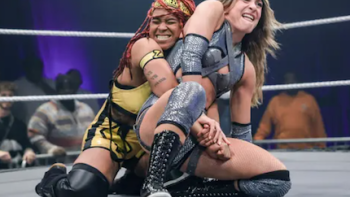 WWE Evolve TV show screenshot 2: Two female wrestlers locked in the ring. 