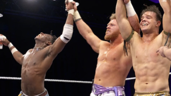 WWE Evolve TV show screenshot 3: Three wrestlers holding hands overhead.