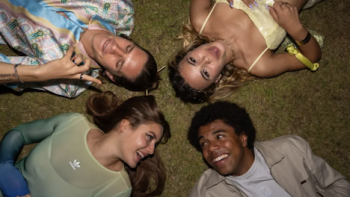 Young Millionaires TV show screenshot 1: Samia, David, Jess, and Léo lie on pavement with heads together. 