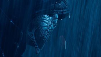 Close-up of El Chicano's masked face under the rain