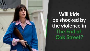 A woman in a blue coat holds a shotgun on a porch.
