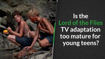 Two boys with mud on skin sit on rocks, one holds a yellow fruit