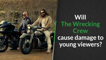 “Two men wearing sunglasses sit on motorcycles on a dirt road, surrounded by dry brush and trees, giving a rugged, action-film vibe.