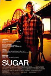 Sugar movie poster: Algenis Perez Soto stands holding a duffle bag on his shoulder in front of a bridge at sunset