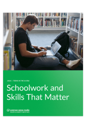 teenaged boy works on laptop in library setting