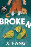 Broken book cover: An orange cat hides behind a girl’s legs and a tea cup sits on the floor, broken into three pieces, amid the title in white letters