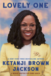 Black woman with glasses and shoulder-length braids in yellow blazer and white shirt