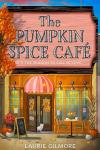 The Pumpkin Spice Cafe book cover: Illustration of the front of a cafe with fall decorations and a white cat coming through the door