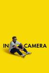 In Camera movie poster: Nabhaan Rizwan sits with his arms resting on his knees against a yellow background