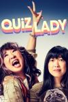 Quiz Lady movie poster: Sandra Oh yells out in joy with hand raised in peace symbol on left as Awkwafina stands next to her holding a pug puppy on right