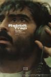 Rabbit Trap movie poster: A blurred image of Dev Patel's face, his hands holding large headphones on his ears