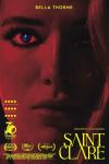 Saint Clare Movie Poster: The face of Clare (Bella Thorne) is bathed in red light, an image of a cross glinting in her eye