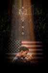 Stand movie poster: In front of American flag and basketball hoop, profile of Black man center with head lowered and hands up in prayer