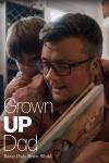 Grown Up Dad TV poster: A white dad wearing glasses reads to his son
