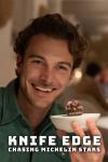 Knife Edge: Chasing Michelin Stars TV show poster: Host Jesse Burgess smiles as he holds a small chocolate dessert in a small white bowl.