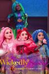 Wickedly Sweet: A Descendants Short Story TV: Three white-skinned dolls, Bridget in Pink, Red in Red, Chloe in Blue & dark-skinned Uliana with braids.