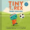 Tiny T. Rex Tries Soccer book cover: Tiny T. Rex, in soccer jersey and cleats, kicks a soccer ball on a green field