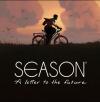 In the product image of SEASON: a letter to the future, the game's protagonist - Estelle - is seen riding a bike through a meadow.
